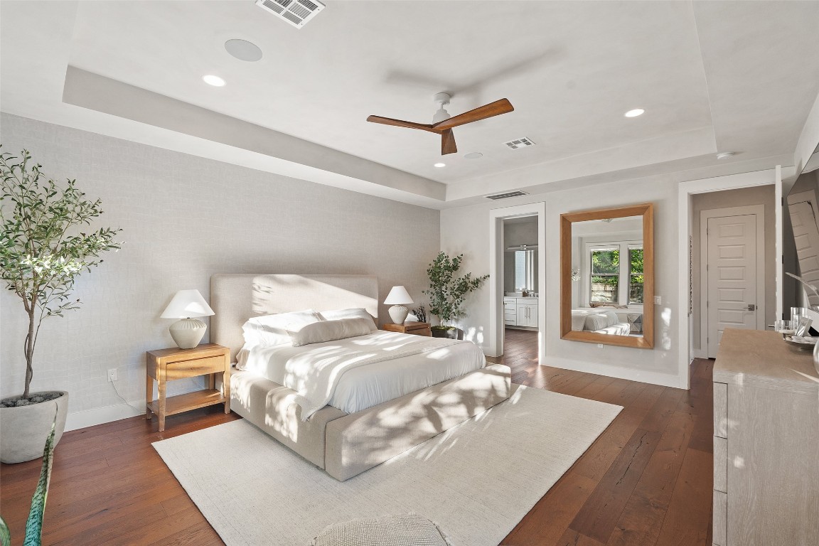 1002 Meriden Lane Austin, TX 78703 - Photo 19 of 35 a bedroom with a large bed and a potted plant