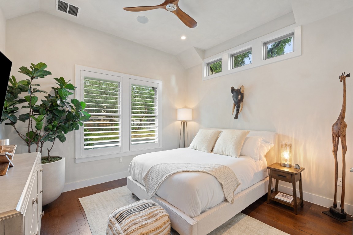 1002 Meriden Lane Austin, TX 78703 - Photo 24 of 35 a bedroom with a bed and a potted plant
