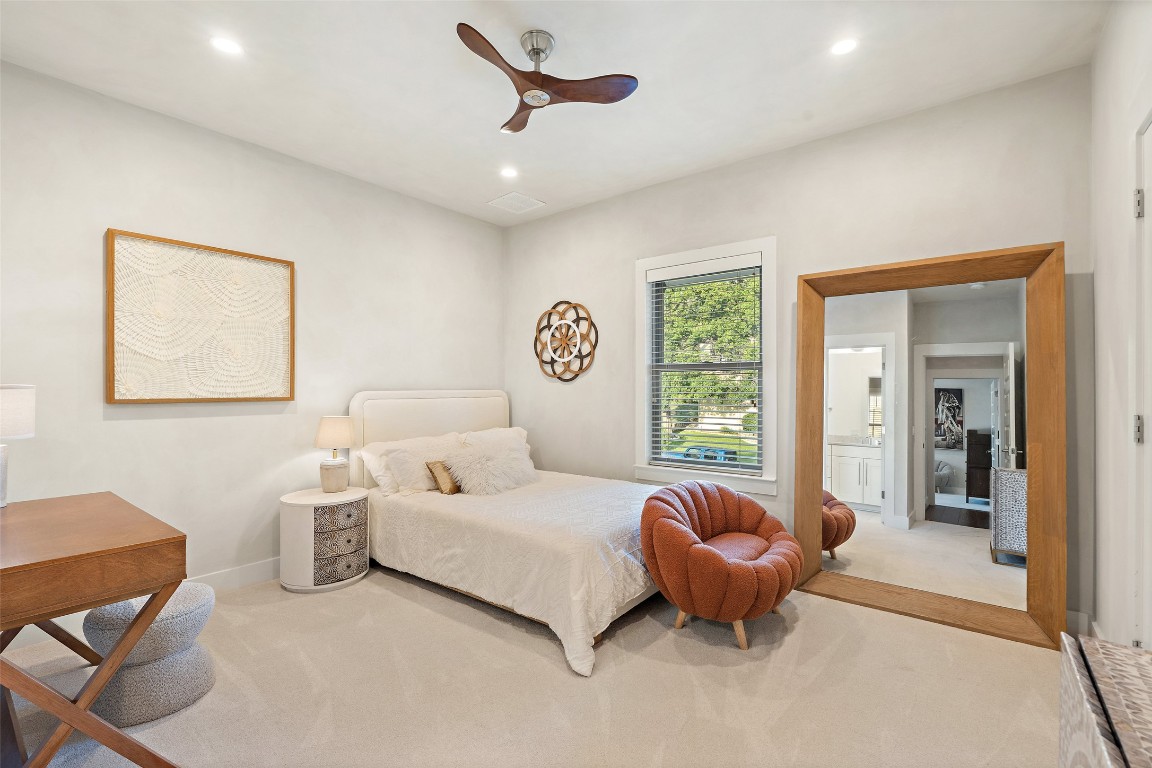 1002 Meriden Lane Austin, TX 78703 - Photo 29 of 35 a spacious bedroom with a bed and glass window