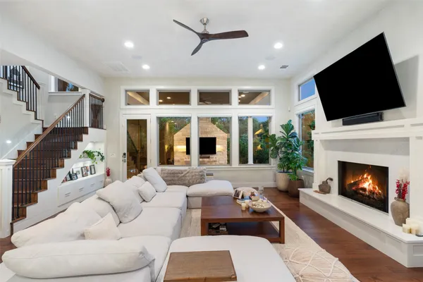 a living room with furniture fireplace and flat screen tv
