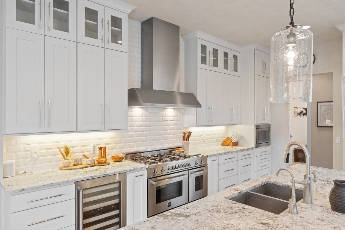1002 Meriden Lane Austin, TX 78703 - Photo 9 of 35 a kitchen with stainless steel appliances granite countertop a sink stove and cabinets