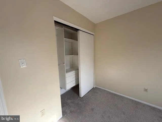 a white toilet sitting next to a white sink