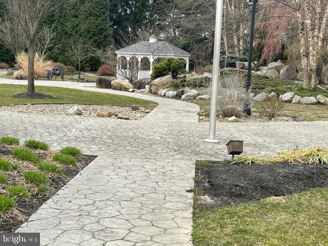 27 Stratton Court Robbinsville, NJ 08691 - Photo 24 of 28 a view of a garden with an outdoor space