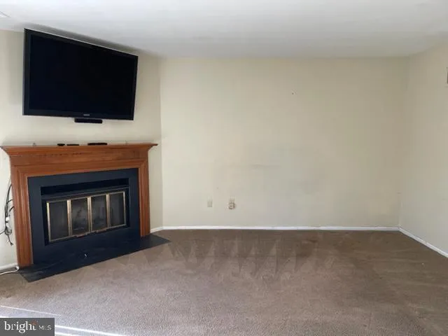 a living room with a fireplace and a flat screen tv