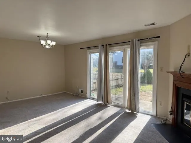 a spacious bedroom with a bed and a chandelier