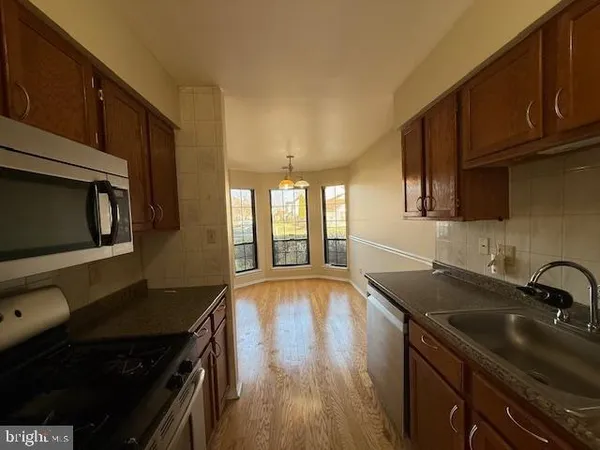 a kitchen that has a sink and a stove