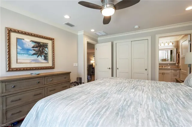 a large bedroom with a bed and a chandelier