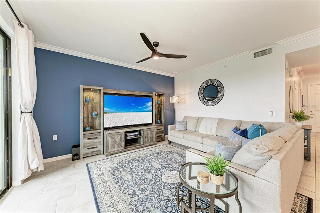 17902 Gawthrop Drive, Unit 307 Lakewood Ranch, FL 34211 - Photo 12 of 74 a living room with furniture and a flat screen tv