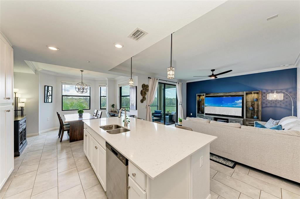 17902 Gawthrop Drive, Unit 307 Lakewood Ranch, FL 34211 - Photo 20 of 74 a large kitchen with kitchen island a large counter top space a sink a window and stainless steel appliances