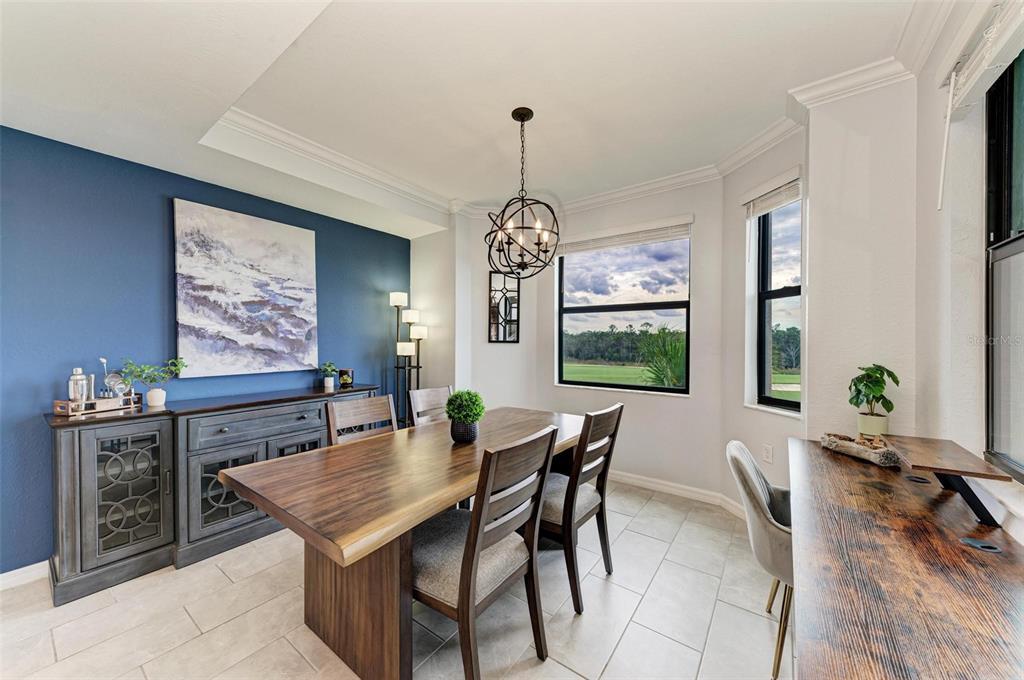 17902 Gawthrop Drive, Unit 307 Lakewood Ranch, FL 34211 - Photo 22 of 74 a dining room with furniture a rug and a chandelier