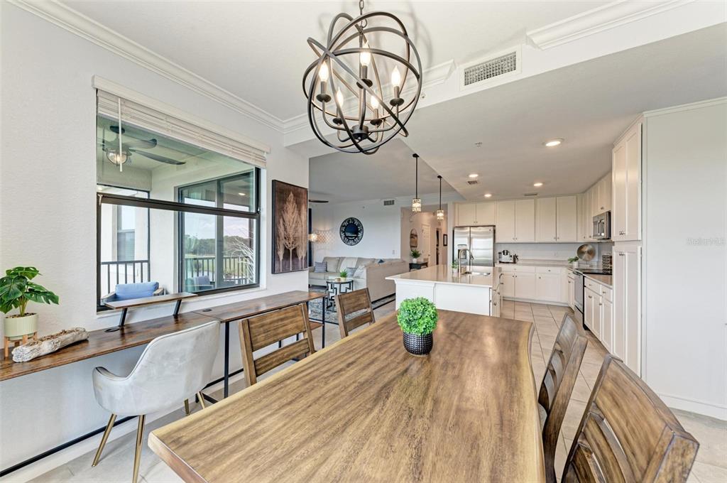 17902 Gawthrop Drive, Unit 307 Lakewood Ranch, FL 34211 - Photo 23 of 74 a view of a dining room and livingroom with furniture a flat screen tv and a large window