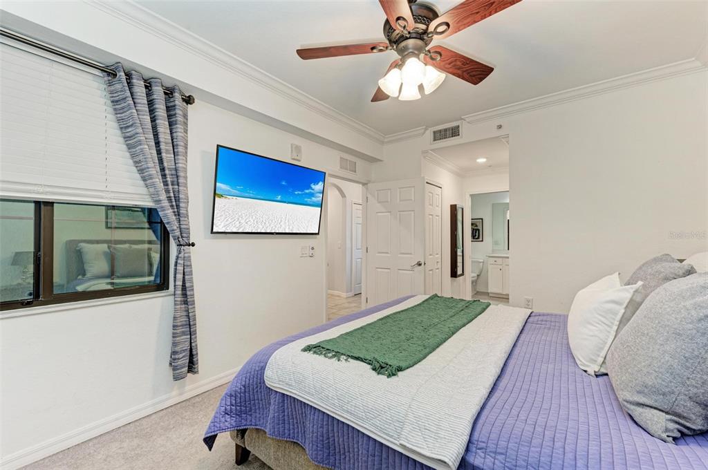 17902 Gawthrop Drive, Unit 307 Lakewood Ranch, FL 34211 - Photo 26 of 74 a bedroom with a bed and a flat screen tv