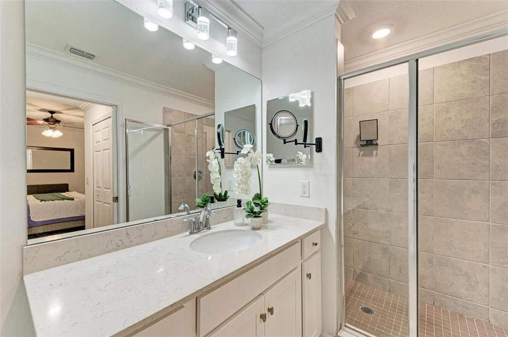 17902 Gawthrop Drive, Unit 307 Lakewood Ranch, FL 34211 - Photo 27 of 74 a bathroom with a shower sink and mirror