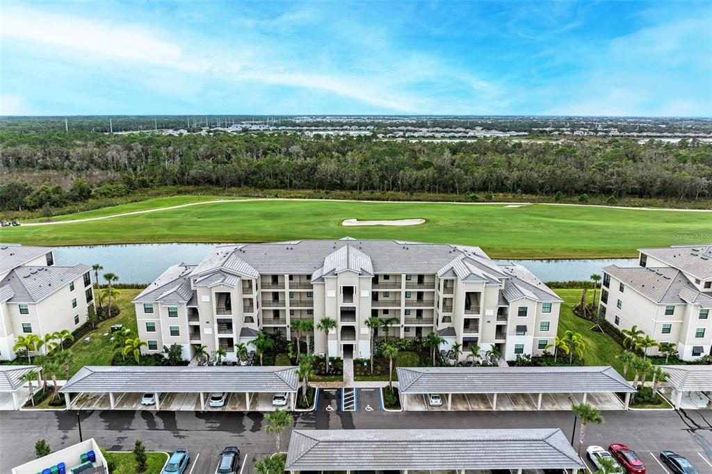 17902 Gawthrop Drive, Unit 307 Lakewood Ranch, FL 34211 - Photo 41 of 74 a view of a big room with a big yard and large trees