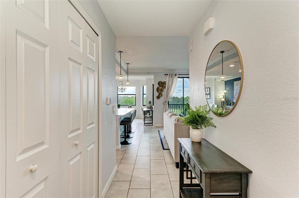 17902 Gawthrop Drive, Unit 307 Lakewood Ranch, FL 34211 - Photo 10 of 74 a view of a hallway to a livingroom with furniture and wooden floor