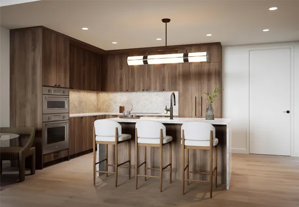 a kitchen with a table chairs refrigerator and microwave