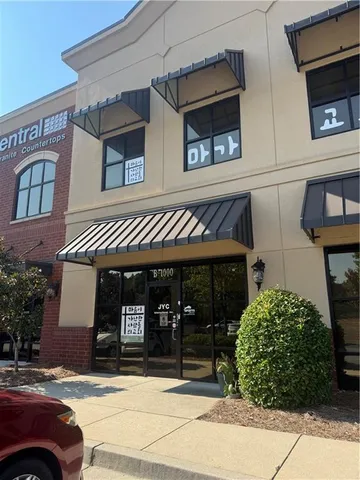 a front view of a house with parking space