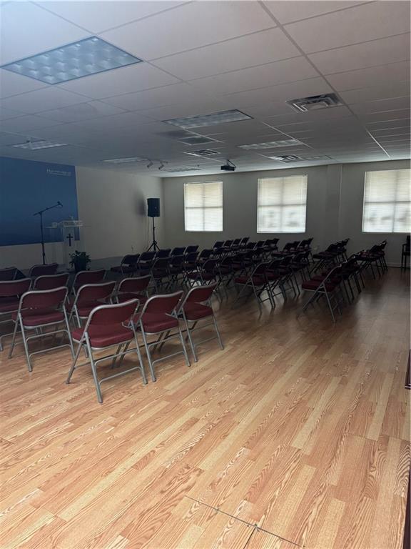 2730 North Berkeley Lake Road Northwest, Unit B1000 Duluth, GA 30096 - Photo 13 of 15 a room with chairs and wooden floor