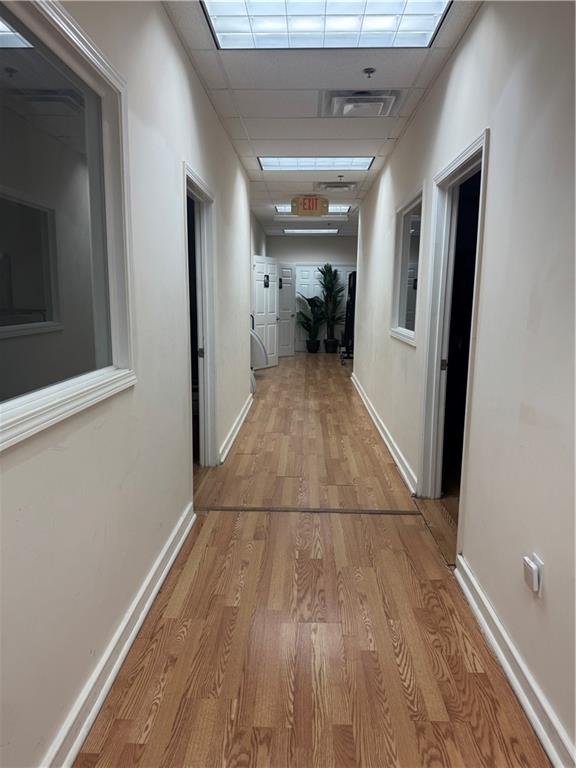 2730 North Berkeley Lake Road Northwest, Unit B1000 Duluth, GA 30096 - Photo 10 of 15 a view of a hallway with wooden floor and a kitchen space