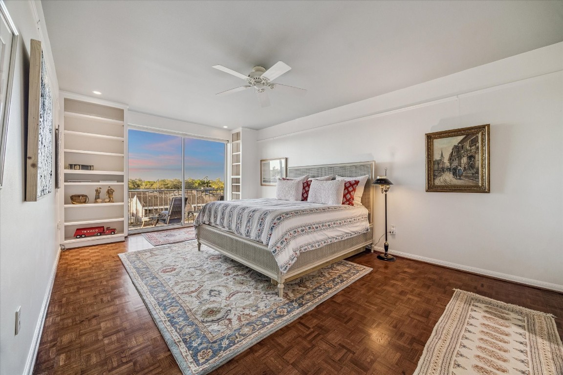 2200 Willowick Road, Unit 4D Houston, TX 77027 - Photo 15 of 36 a bedroom with a large bed a rug and paintings on the wall