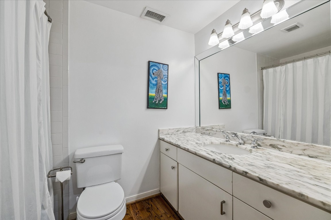 2200 Willowick Road, Unit 4D Houston, TX 77027 - Photo 20 of 36 a bathroom with a granite countertop sink vanity mirror and toilet