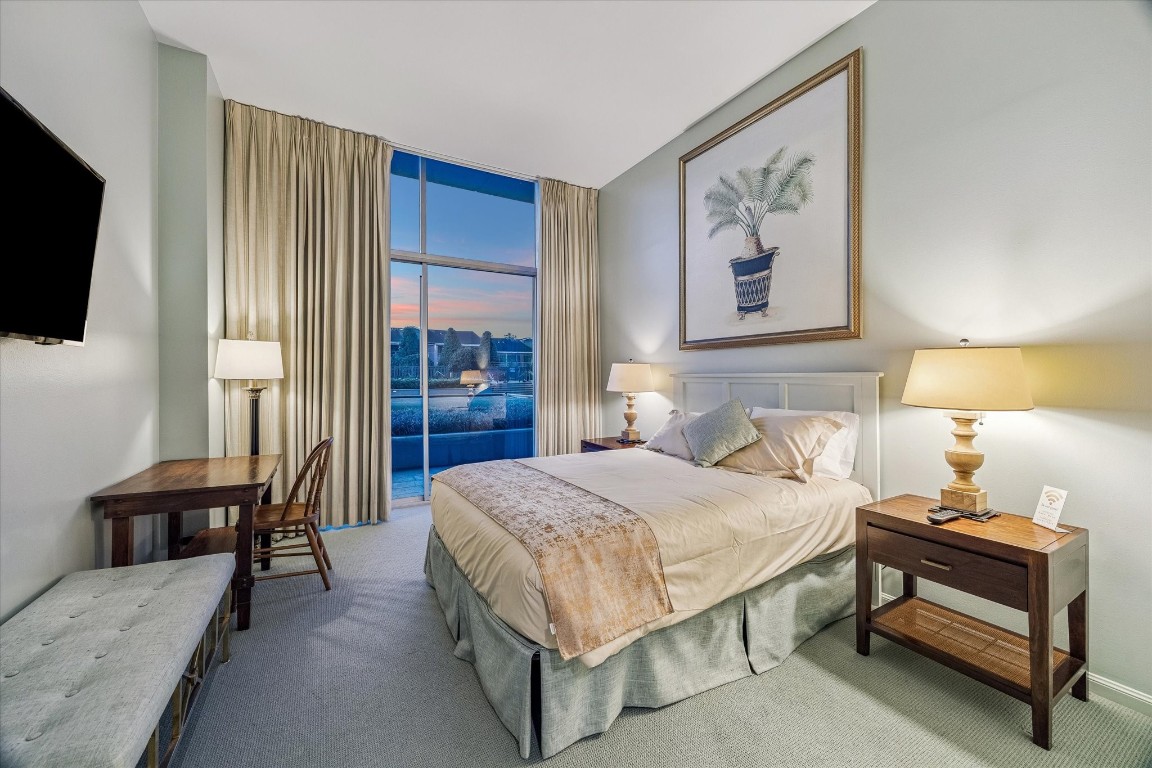 2200 Willowick Road, Unit 4D Houston, TX 77027 - Photo 26 of 36 a bedroom with a bed and a flat screen tv