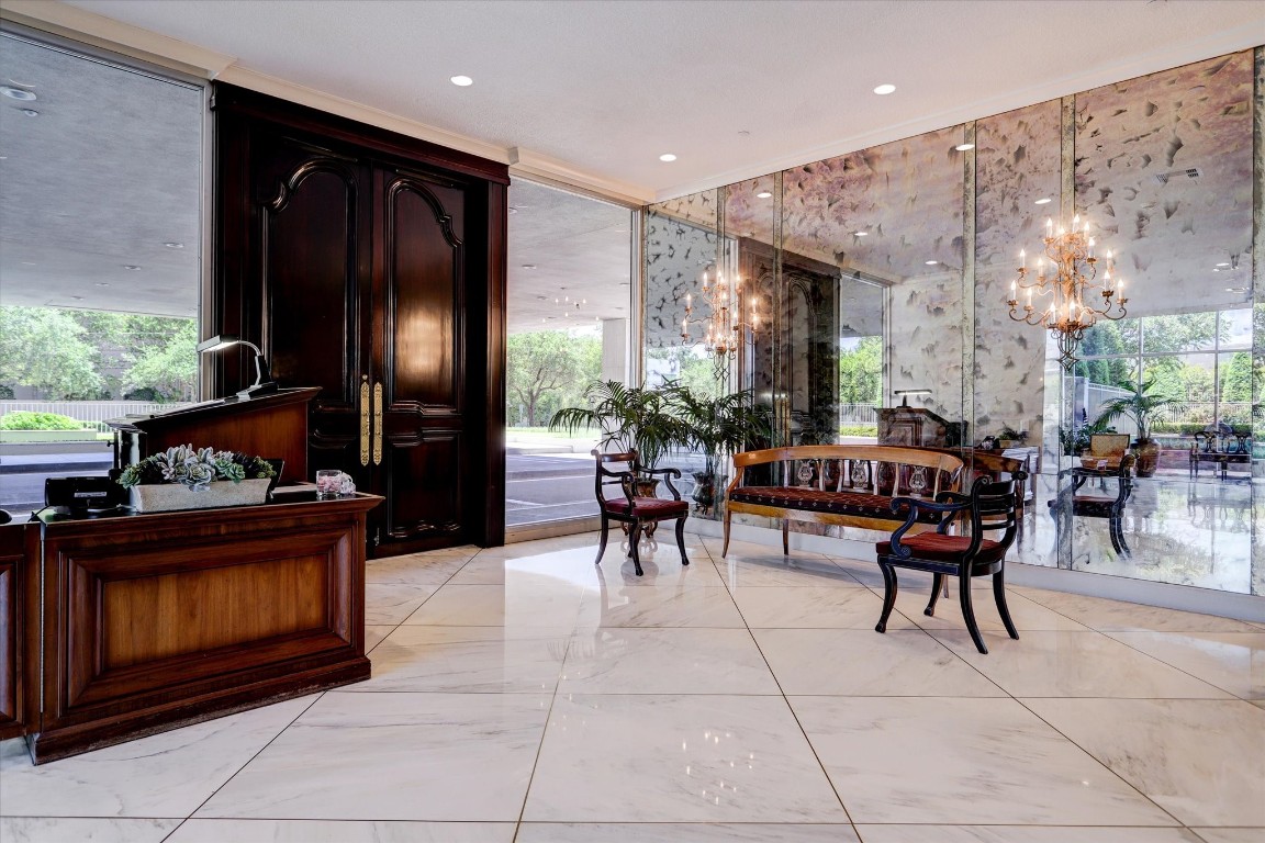2200 Willowick Road, Unit 4D Houston, TX 77027 - Photo 35 of 36 a living room with furniture a fireplace and large windows