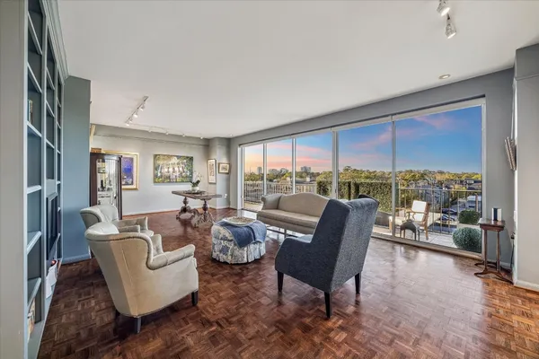 a kitchen with stainless steel appliances a refrigerator a stove a sink and a dining table with garden view