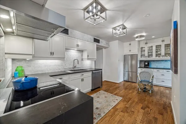 a kitchen with stainless steel appliances granite countertop a stove and a sink