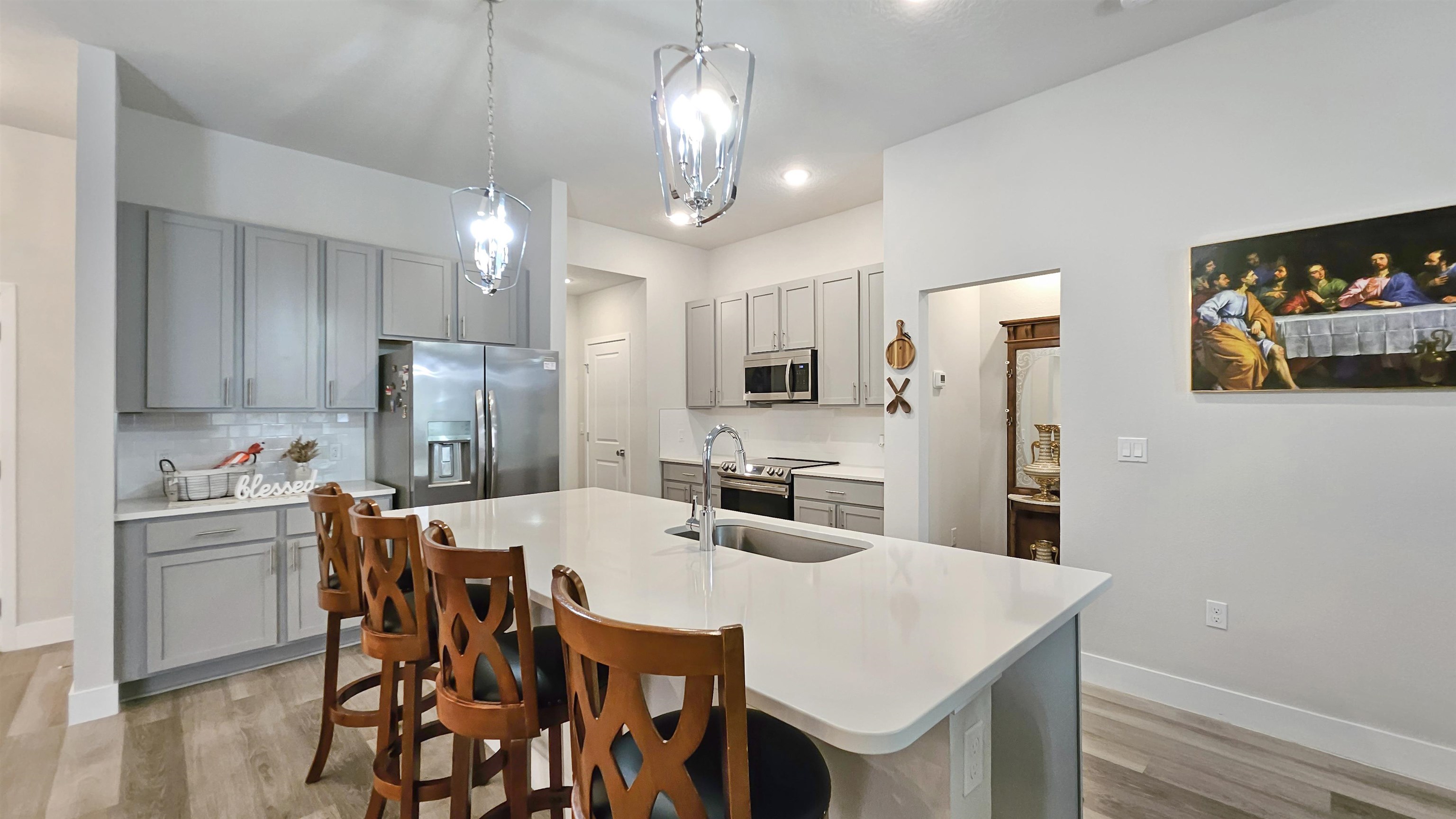 7 Smith Trail Palm Coast, FL 32164 - Photo 11 of 48 a kitchen with stainless steel appliances a table chairs refrigerator and microwave