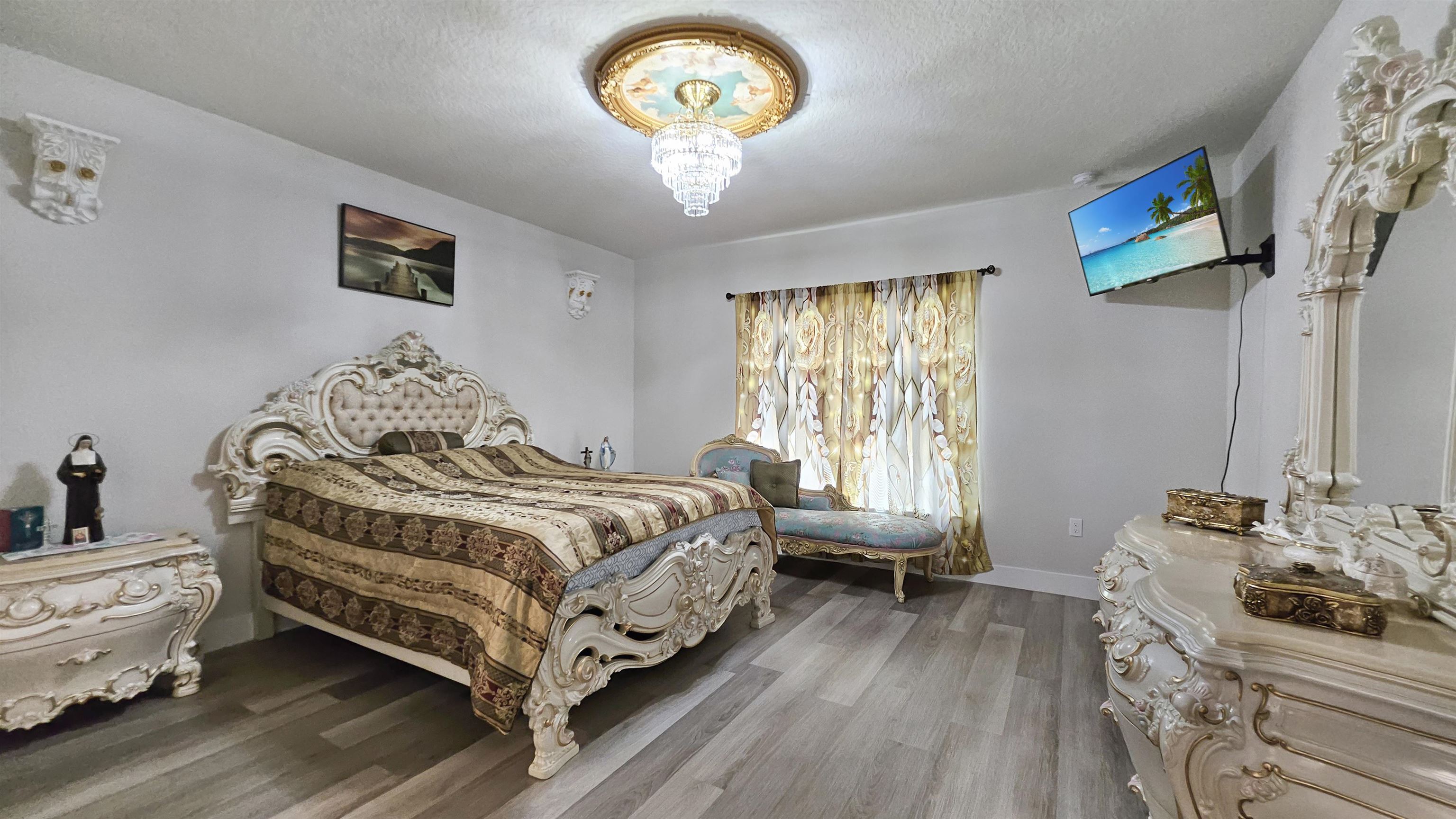 7 Smith Trail Palm Coast, FL 32164 - Photo 18 of 48 a bedroom with a bed and a chandelier