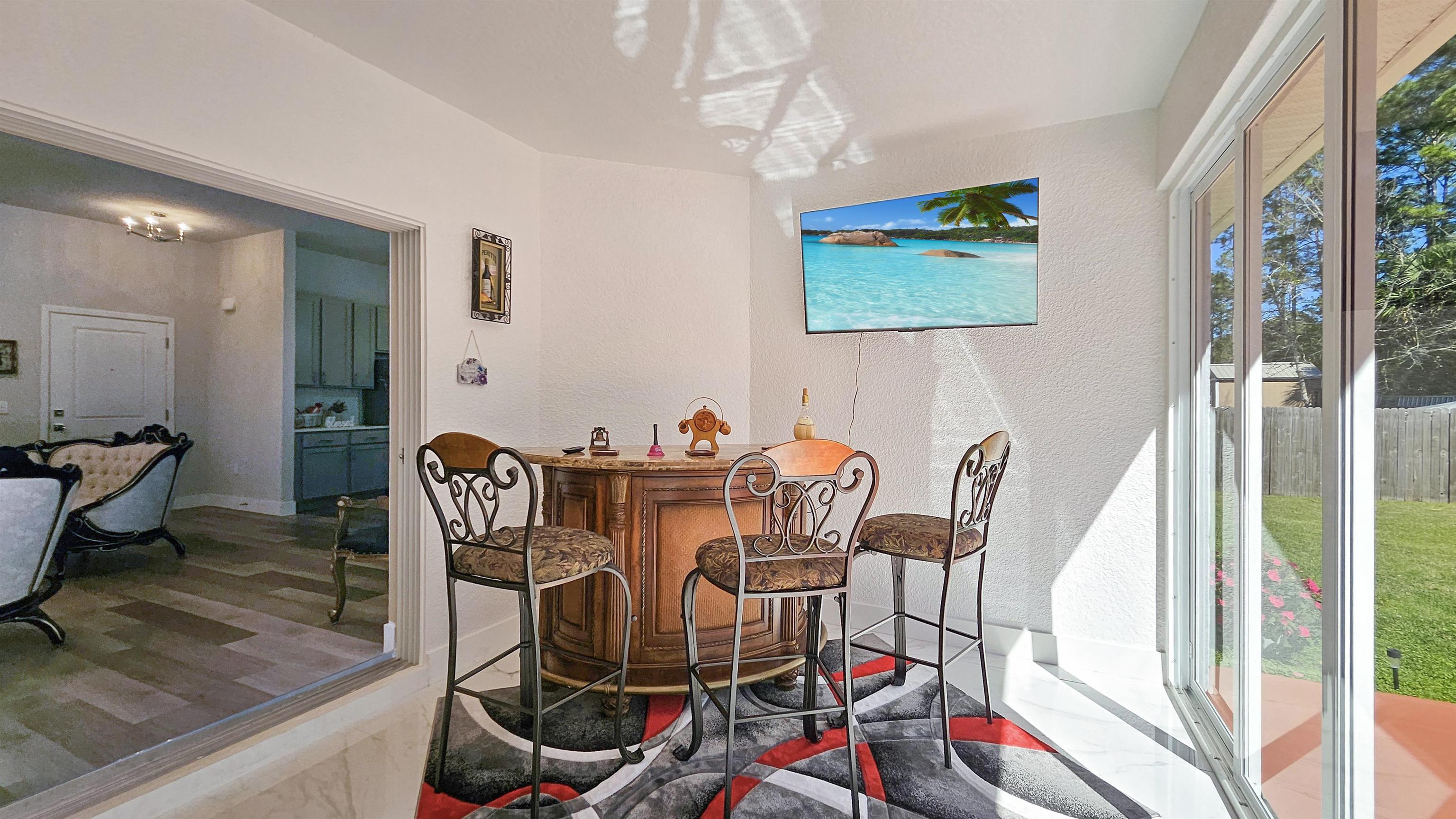 7 Smith Trail Palm Coast, FL 32164 - Photo 30 of 48 a view of a dining room with furniture wooden floor and a chandelier