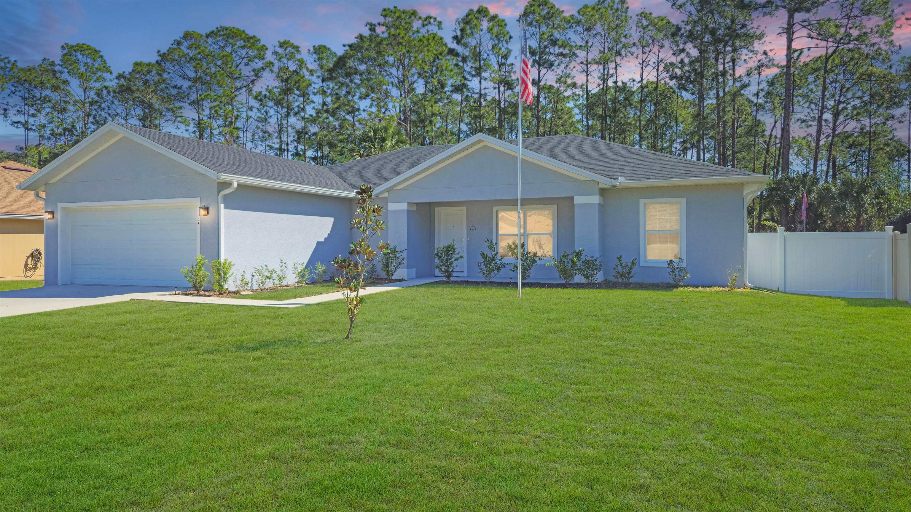 7 Smith Trail Palm Coast, FL 32164 - Photo 3 of 48 a front view of a house with a yard and garage