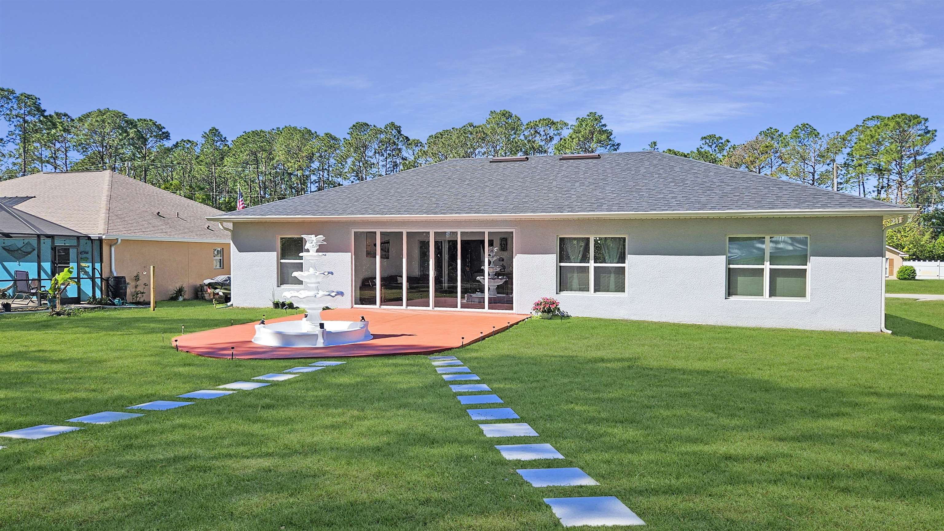 7 Smith Trail Palm Coast, FL 32164 - Photo 34 of 48 a front view of a house with a yard table and chairs