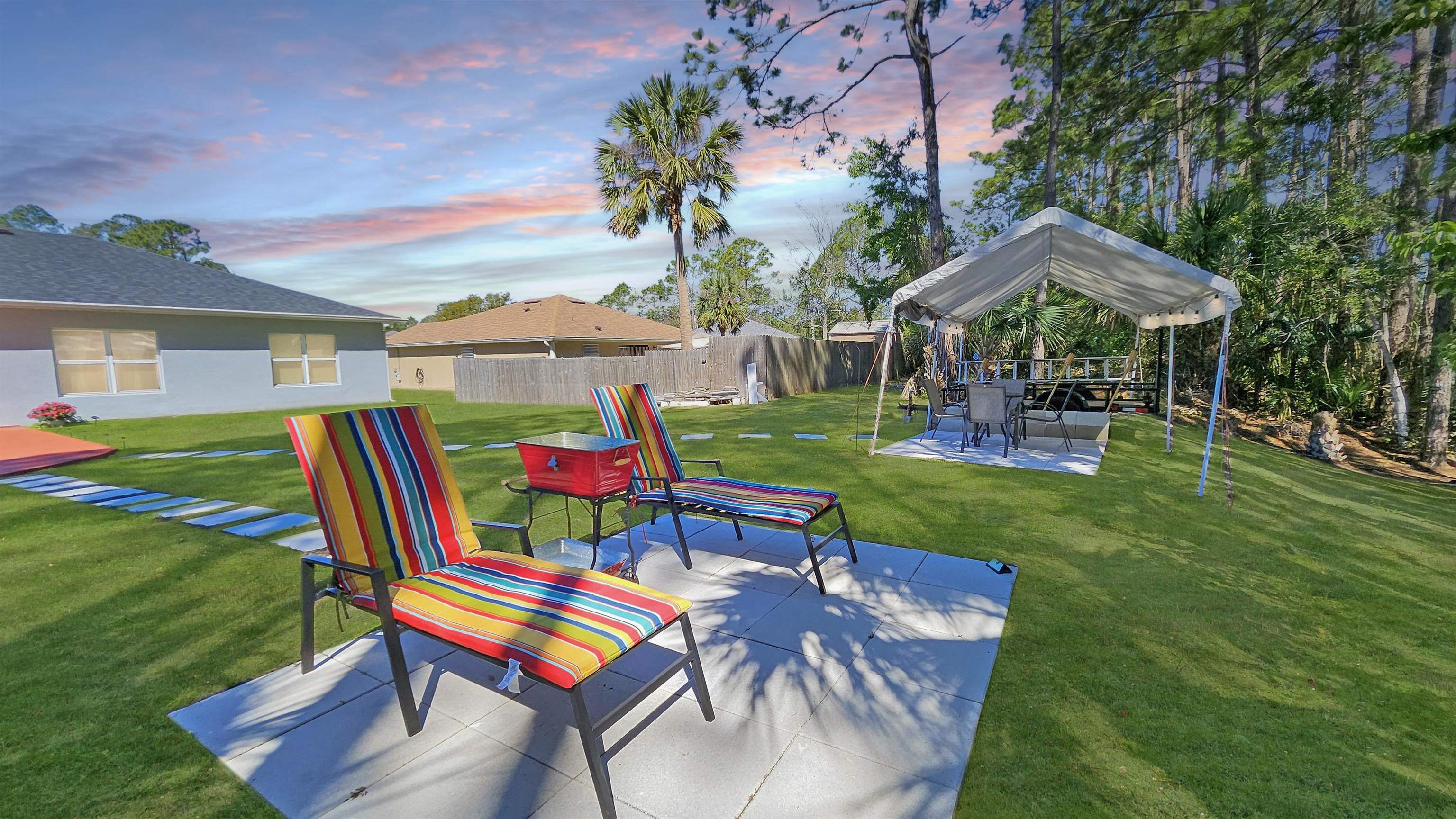7 Smith Trail Palm Coast, FL 32164 - Photo 41 of 48 a front view of a house with a yard table and chairs