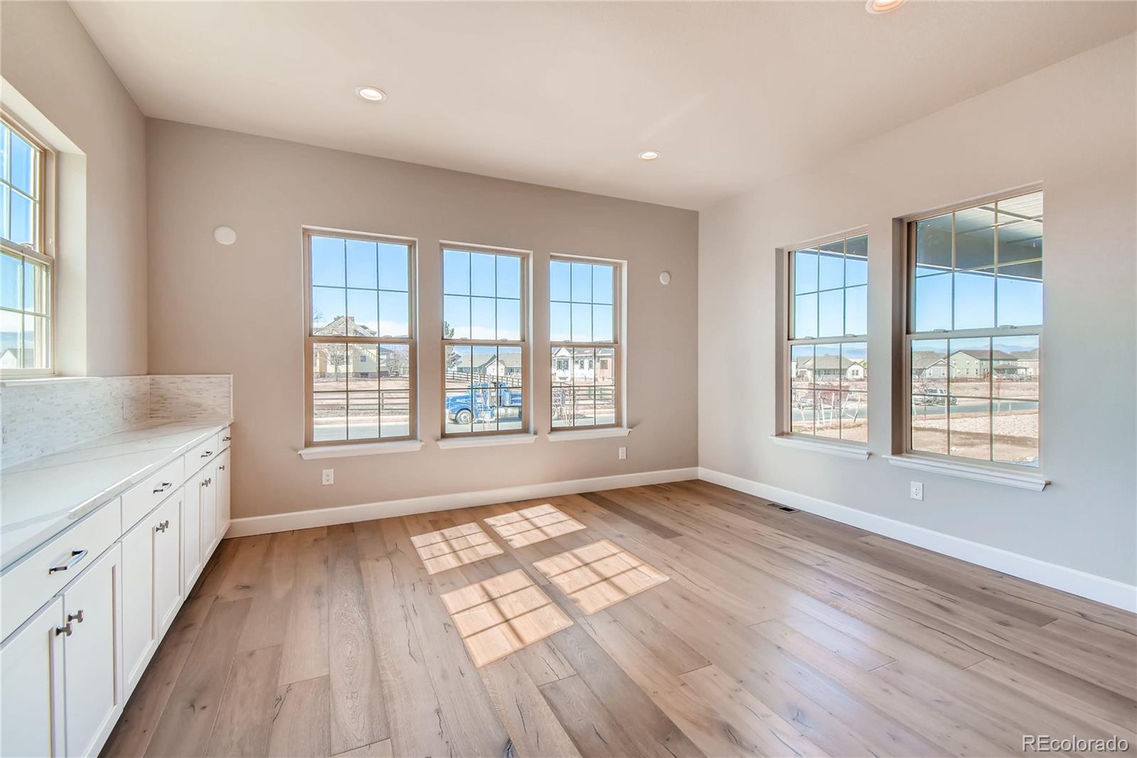 2293 Picadilly Circle Longmont, CO 80503 - Photo 13 of 35 an empty room with wooden floor and windows