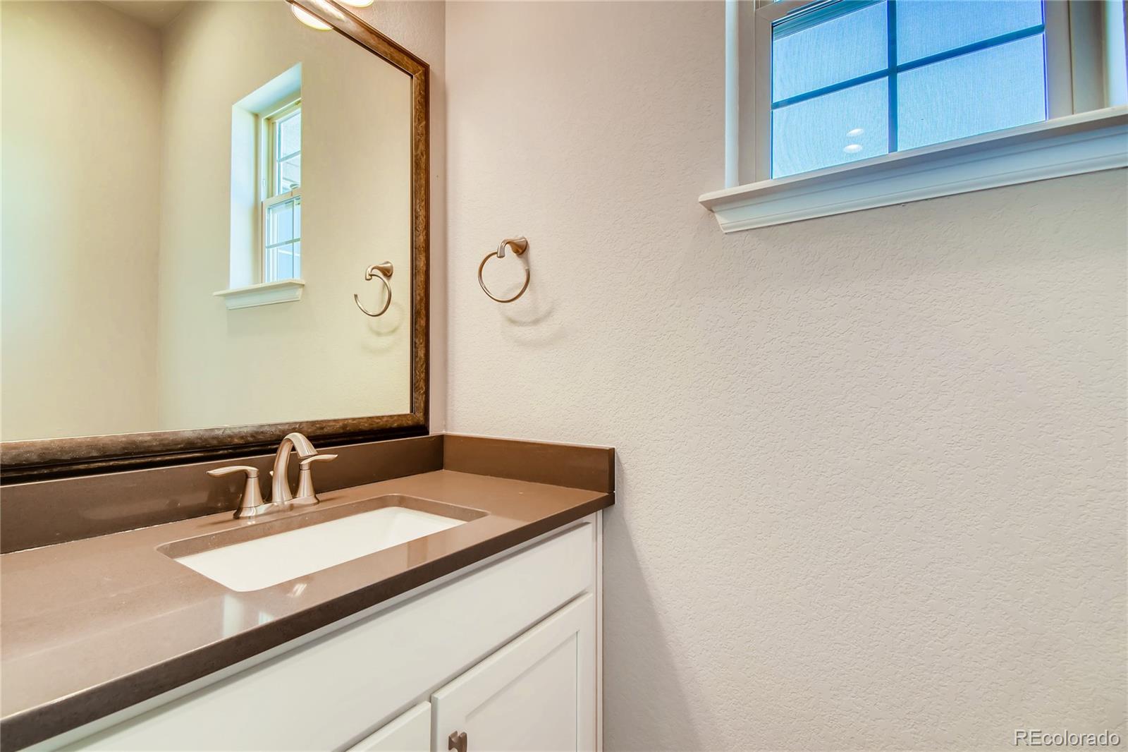 2293 Picadilly Circle Longmont, CO 80503 - Photo 16 of 35 a bathroom with a sink and a mirror