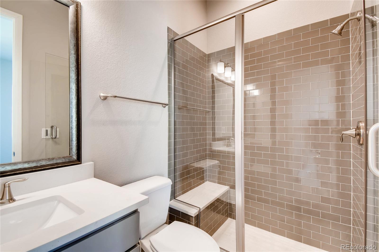 2293 Picadilly Circle Longmont, CO 80503 - Photo 18 of 35 a bathroom with a sink toilet and shower
