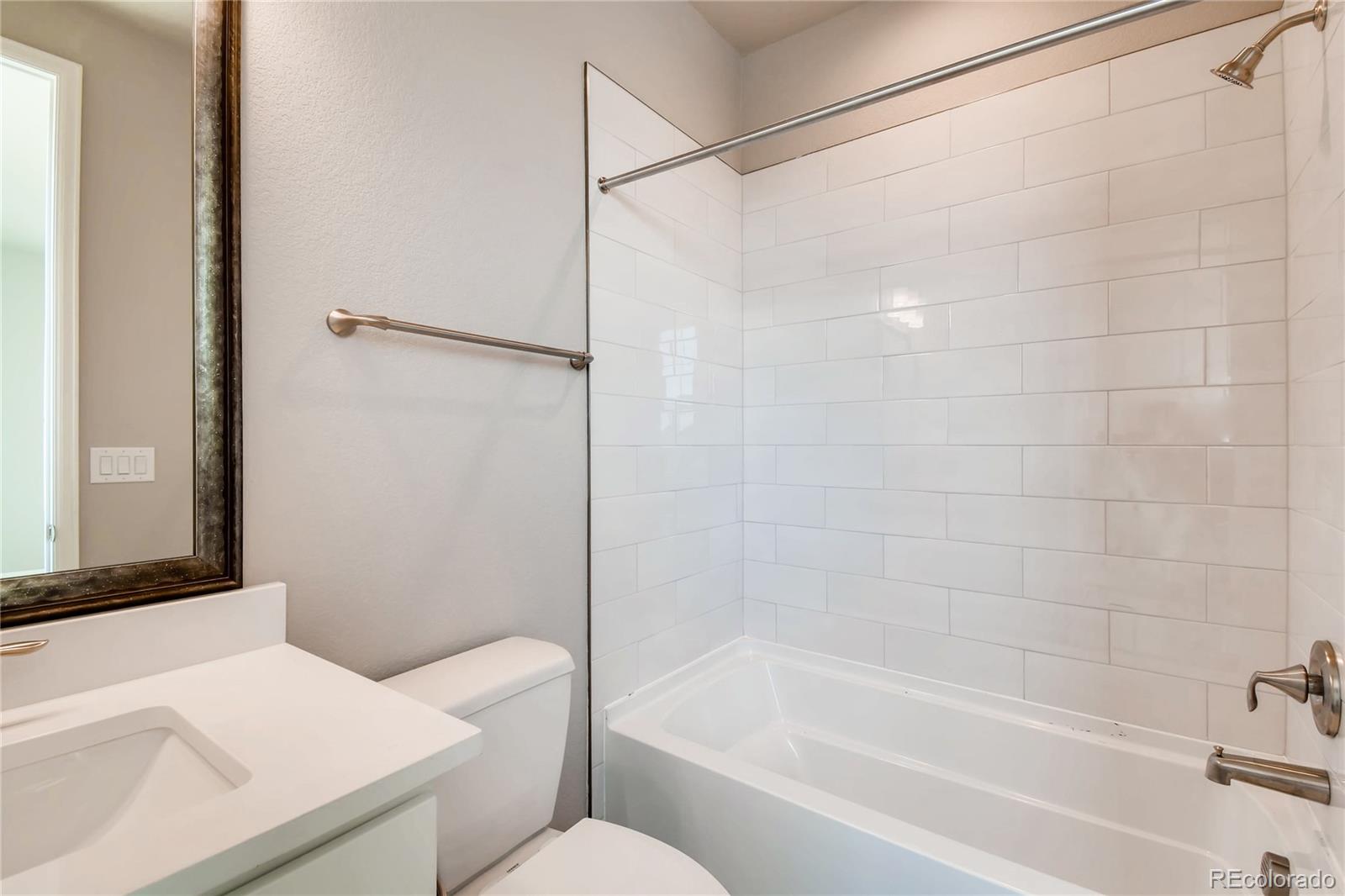2293 Picadilly Circle Longmont, CO 80503 - Photo 20 of 35 a bathroom with a bathtub and a shower