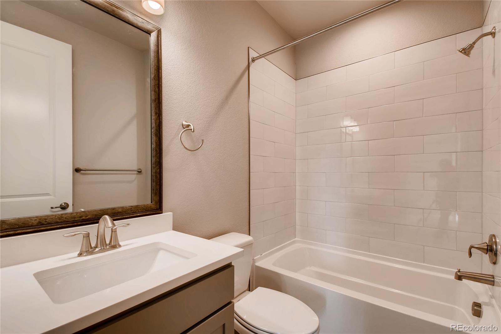 2293 Picadilly Circle Longmont, CO 80503 - Photo 22 of 35 a bathroom with a sink toilet and shower