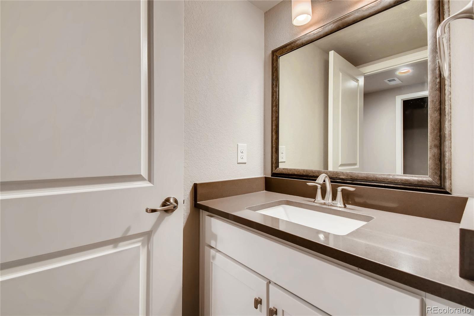 2293 Picadilly Circle Longmont, CO 80503 - Photo 30 of 35 a bathroom with a sink and a mirror