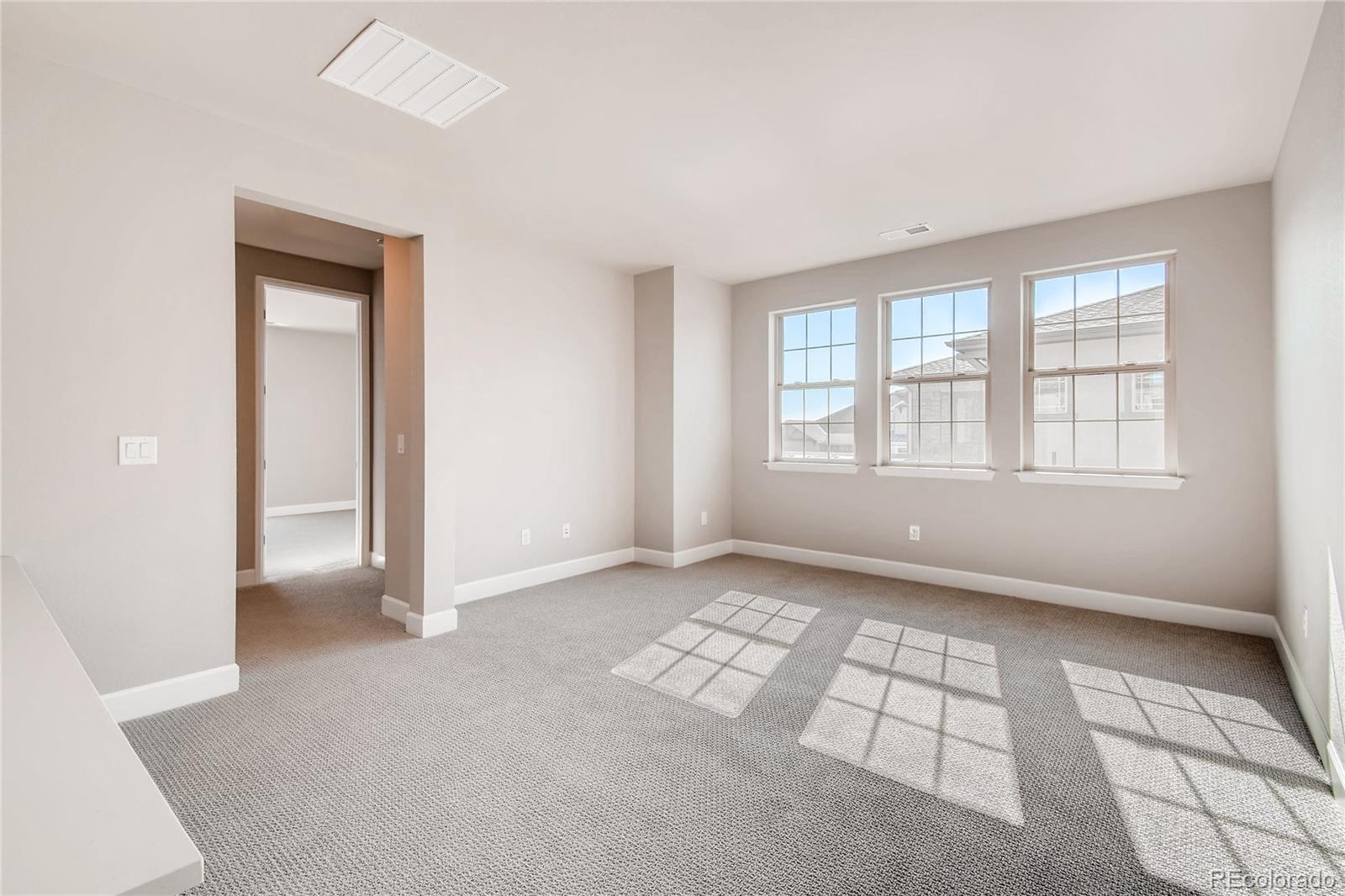 2293 Picadilly Circle Longmont, CO 80503 - Photo 34 of 35 an empty room with windows
