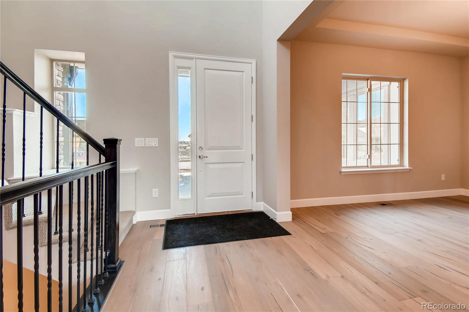 2293 Picadilly Circle Longmont, CO 80503 - Photo 5 of 35 a view of entryway with wooden floor and stairs