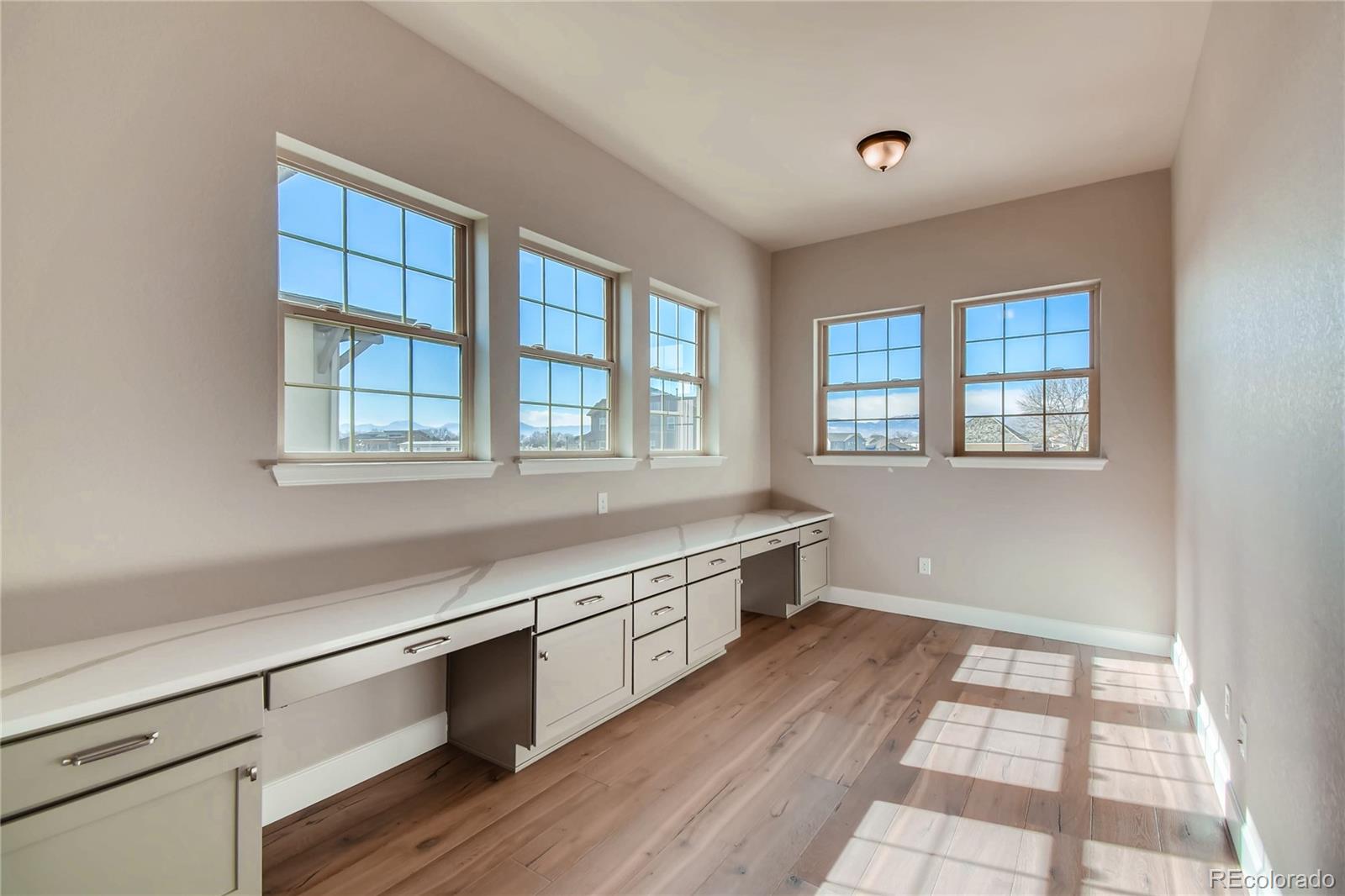 2293 Picadilly Circle Longmont, CO 80503 - Photo 7 of 35 a room with wooden floor and windows