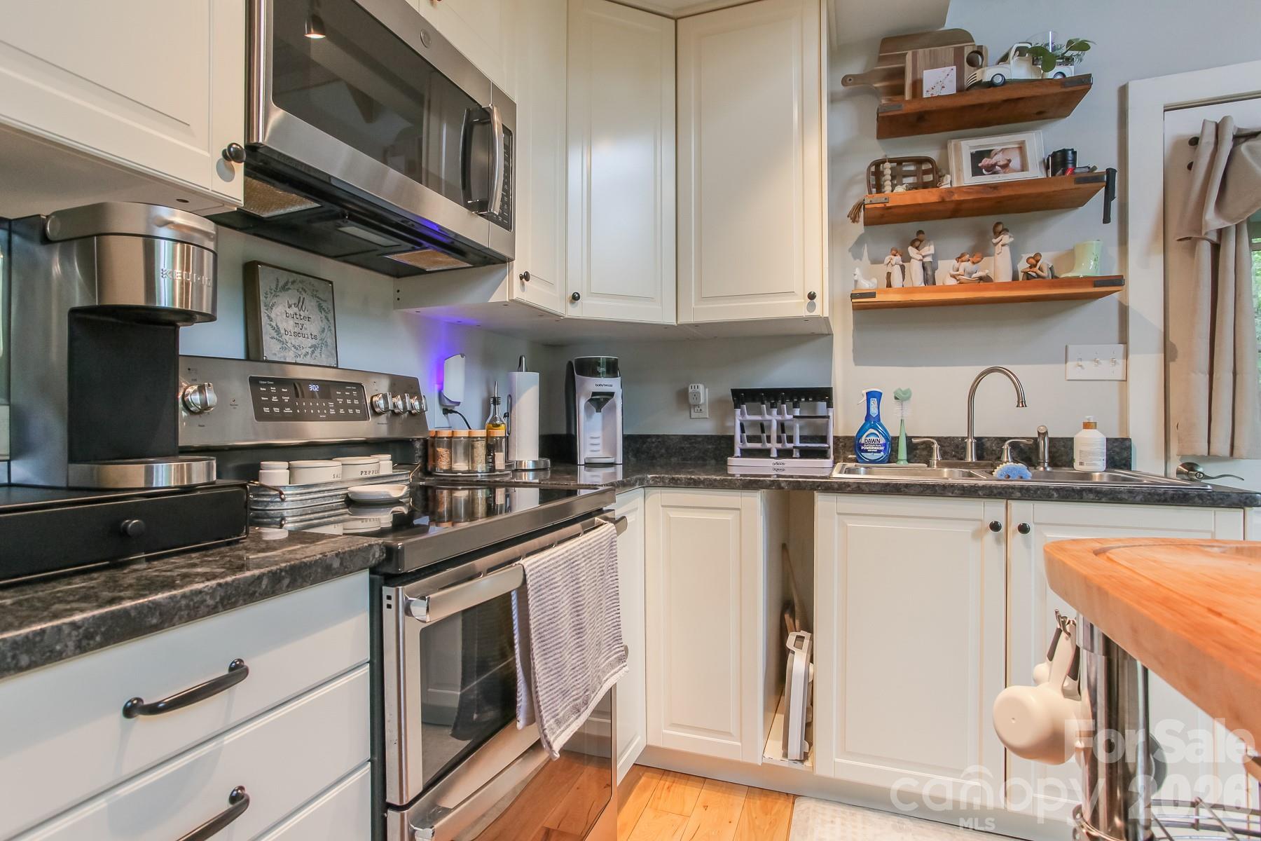 292 Wolf Creek Heights Road Almond, NC 28702 - Photo 16 of 47 a kitchen with stainless steel appliances granite countertop a stove and cabinets