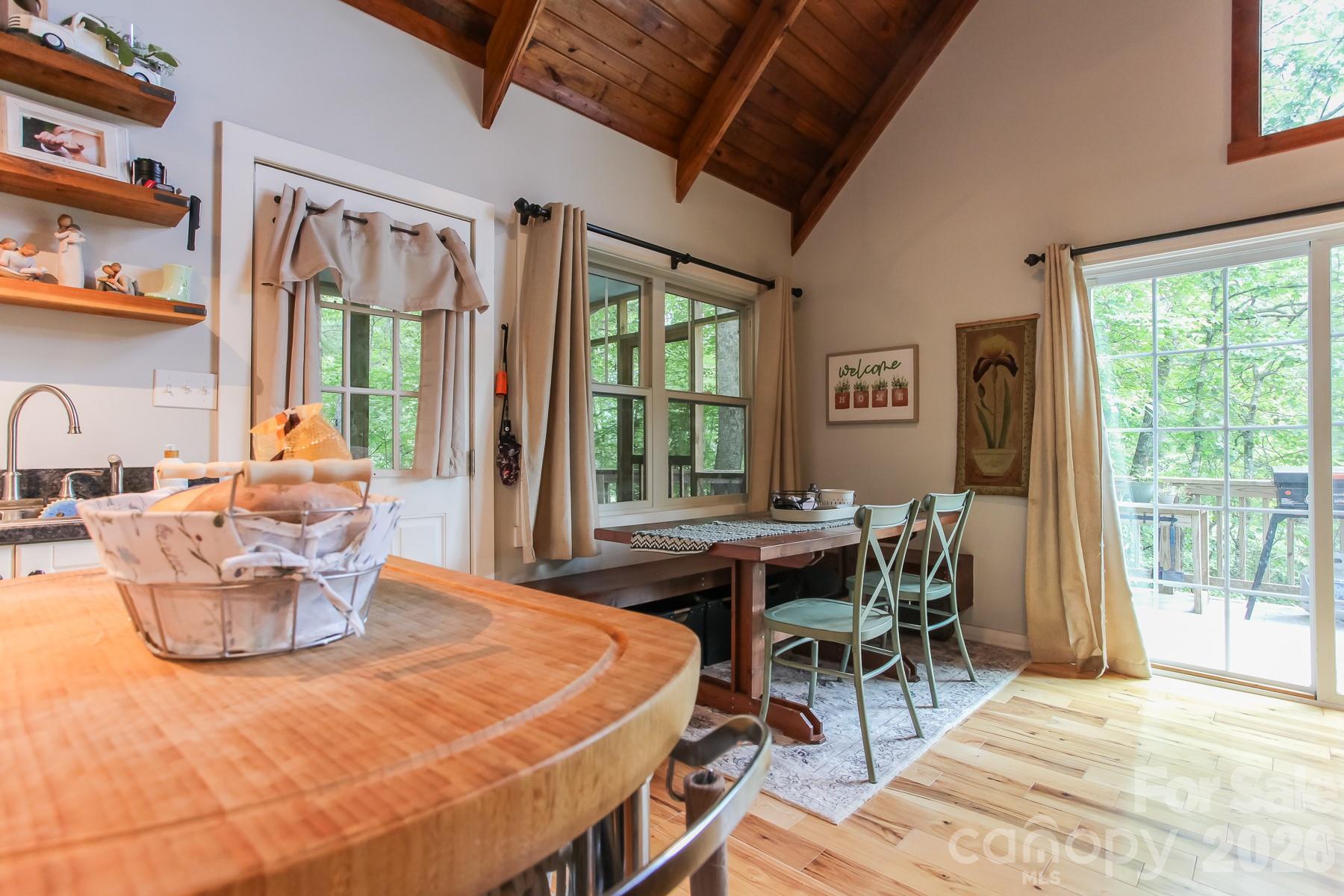 292 Wolf Creek Heights Road Almond, NC 28702 - Photo 17 of 47 a dining room with a table and chairs