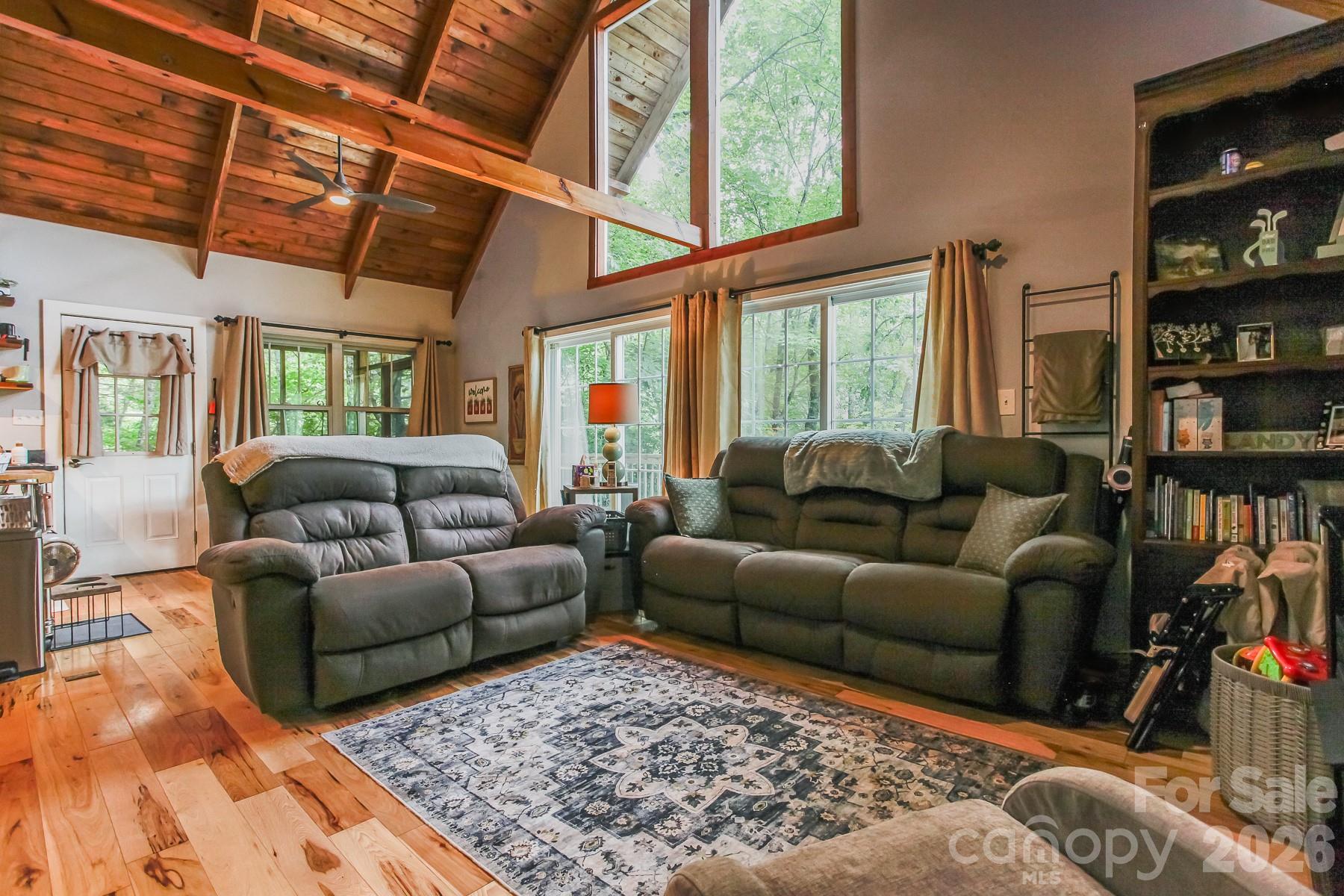 292 Wolf Creek Heights Road Almond, NC 28702 - Photo 19 of 47 a living room with furniture a rug and a large window
