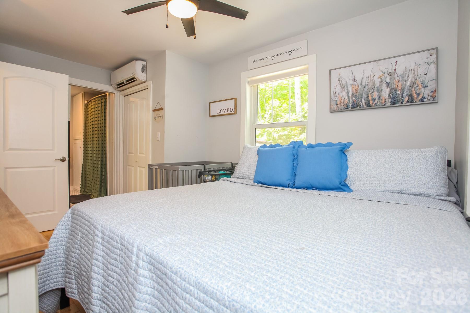 292 Wolf Creek Heights Road Almond, NC 28702 - Photo 25 of 47 a bedroom with a bed and a window