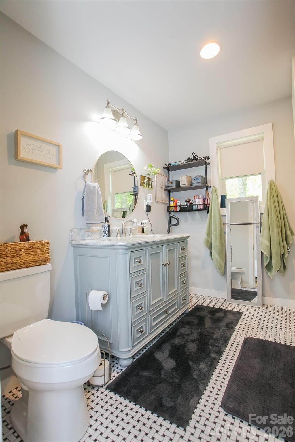 292 Wolf Creek Heights Road Almond, NC 28702 - Photo 26 of 47 a bathroom with a sink a toilet and a mirror