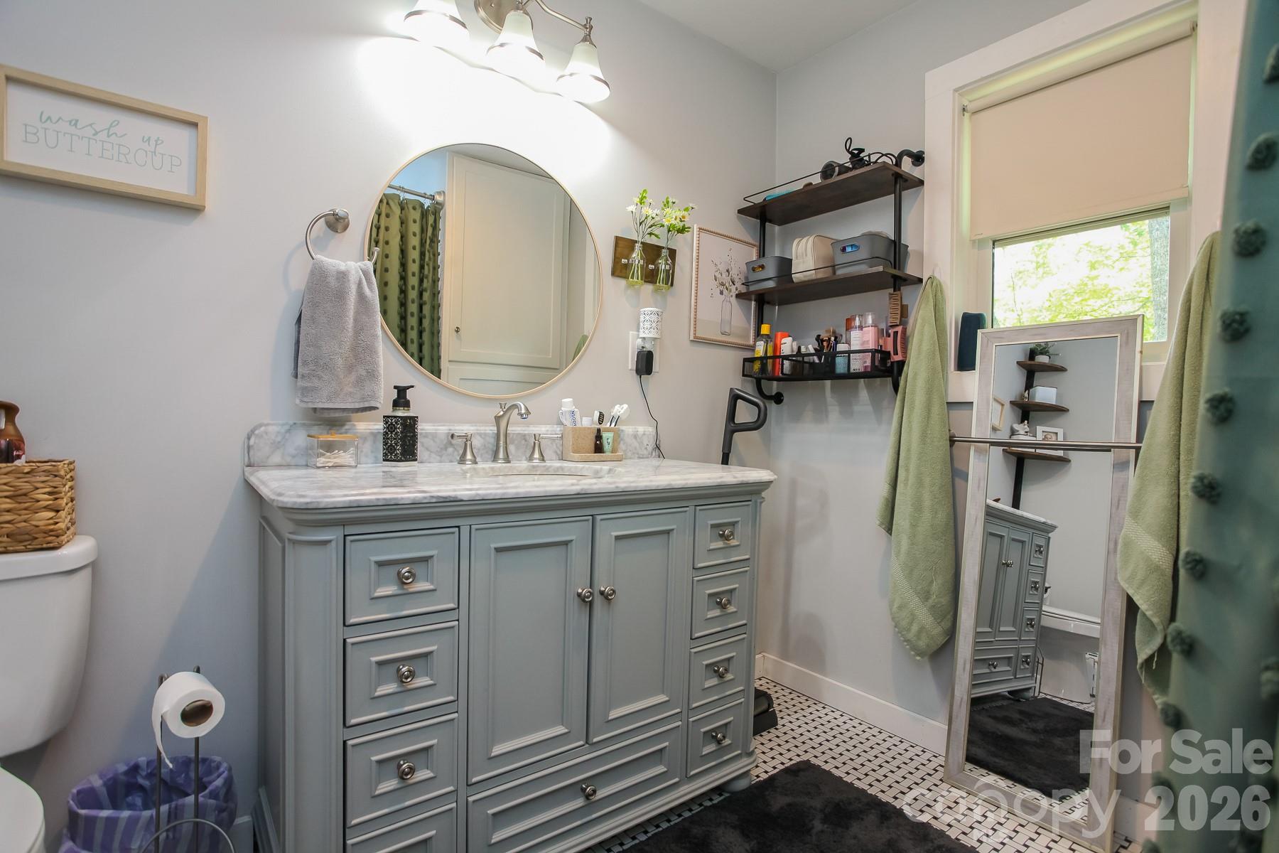 292 Wolf Creek Heights Road Almond, NC 28702 - Photo 28 of 47 a bathroom with a sink mirror and vanity